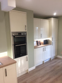 Cream shaker kitchen with integrated oven tower by HSS Carpentry