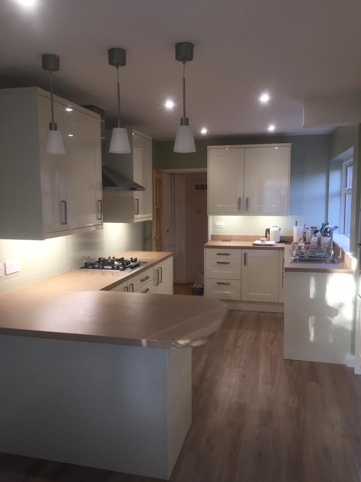 Open plan kitchen with island and pendant lighting fitted by HSS Carpentry